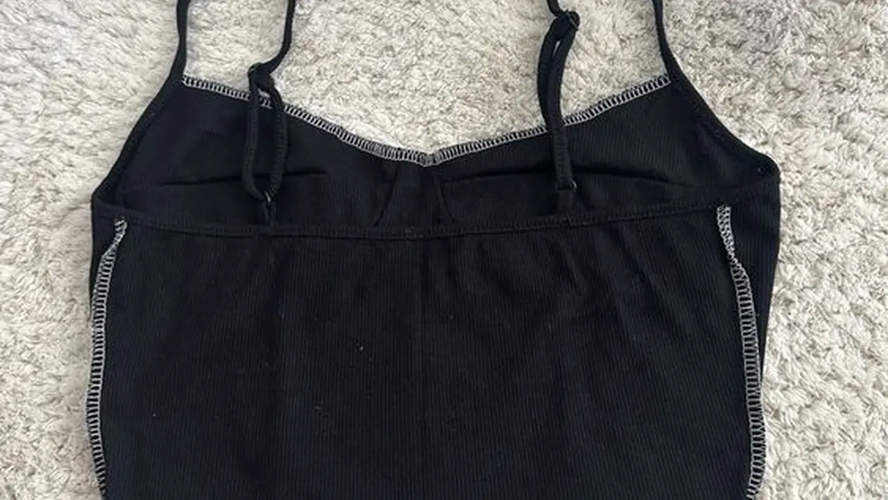 Close up on a plate of mashed potatoes, topped with baked pork chops with cream of mushroom soup, and a side of green beans.